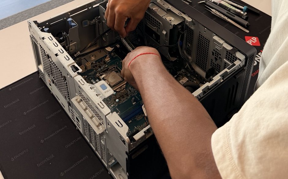 An opened desktop PC tower on the bench with the internal components exposed.
